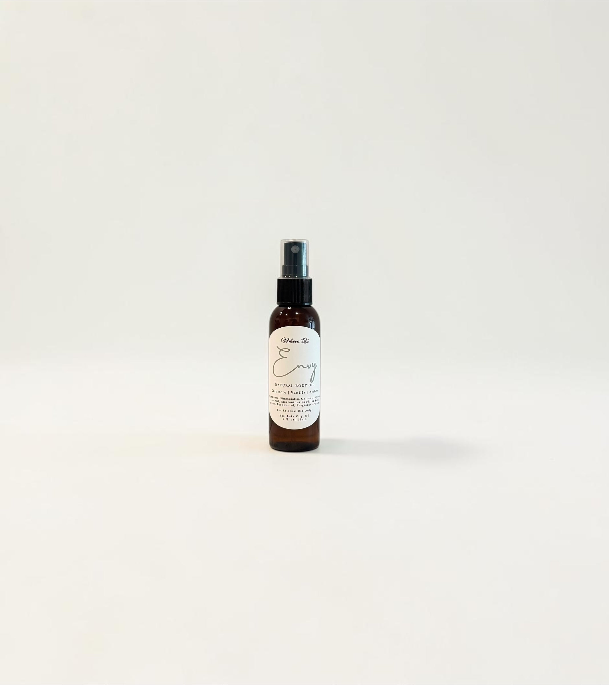 Envy Body Oil — creamy golden vanilla, warm amber, and cashmere‑soft woods photographed on a clean white background.