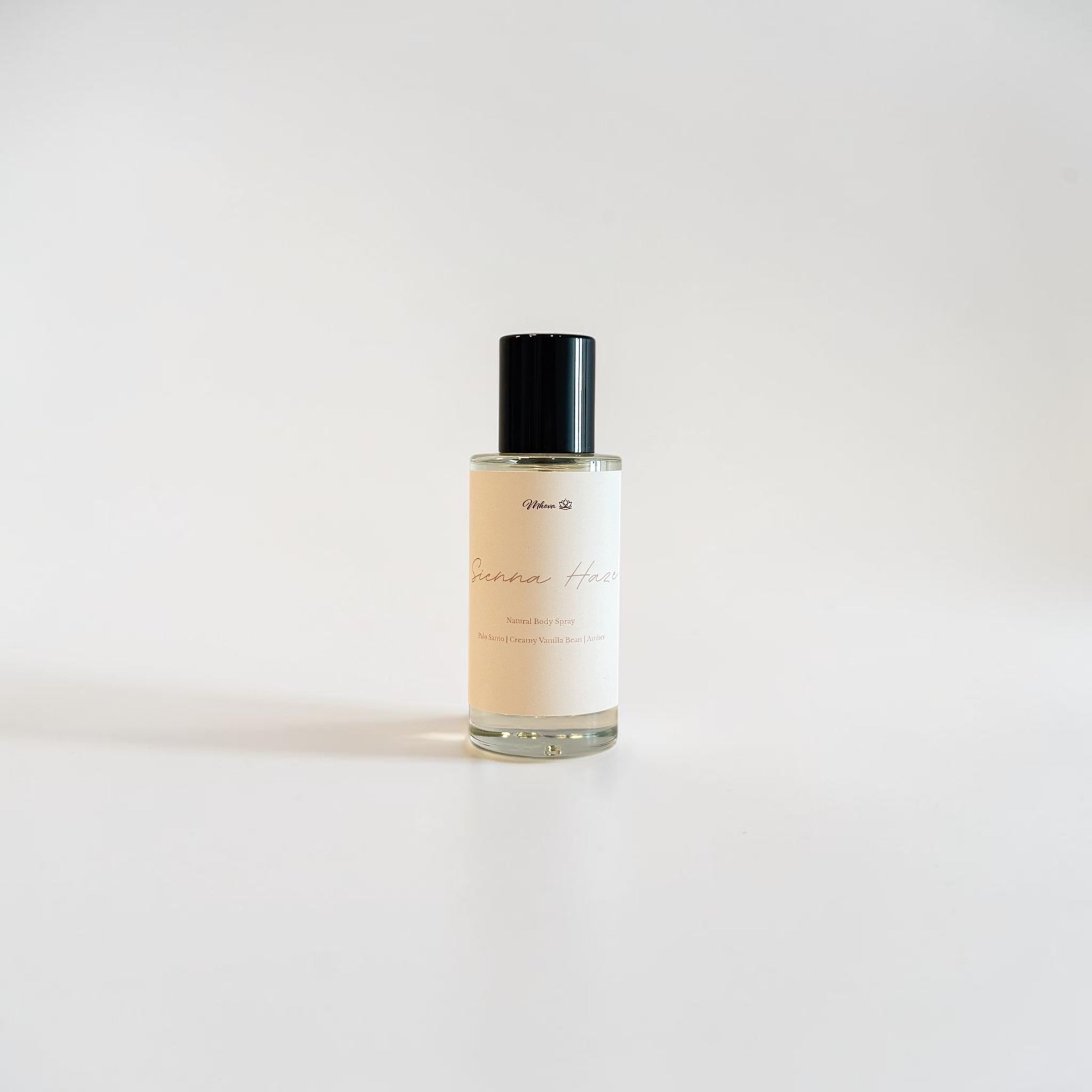 Sienna Haze Fine Fragrance Mist — warm palo santo, creamy vanilla bean, and golden amber scent photographed on a clean white background.