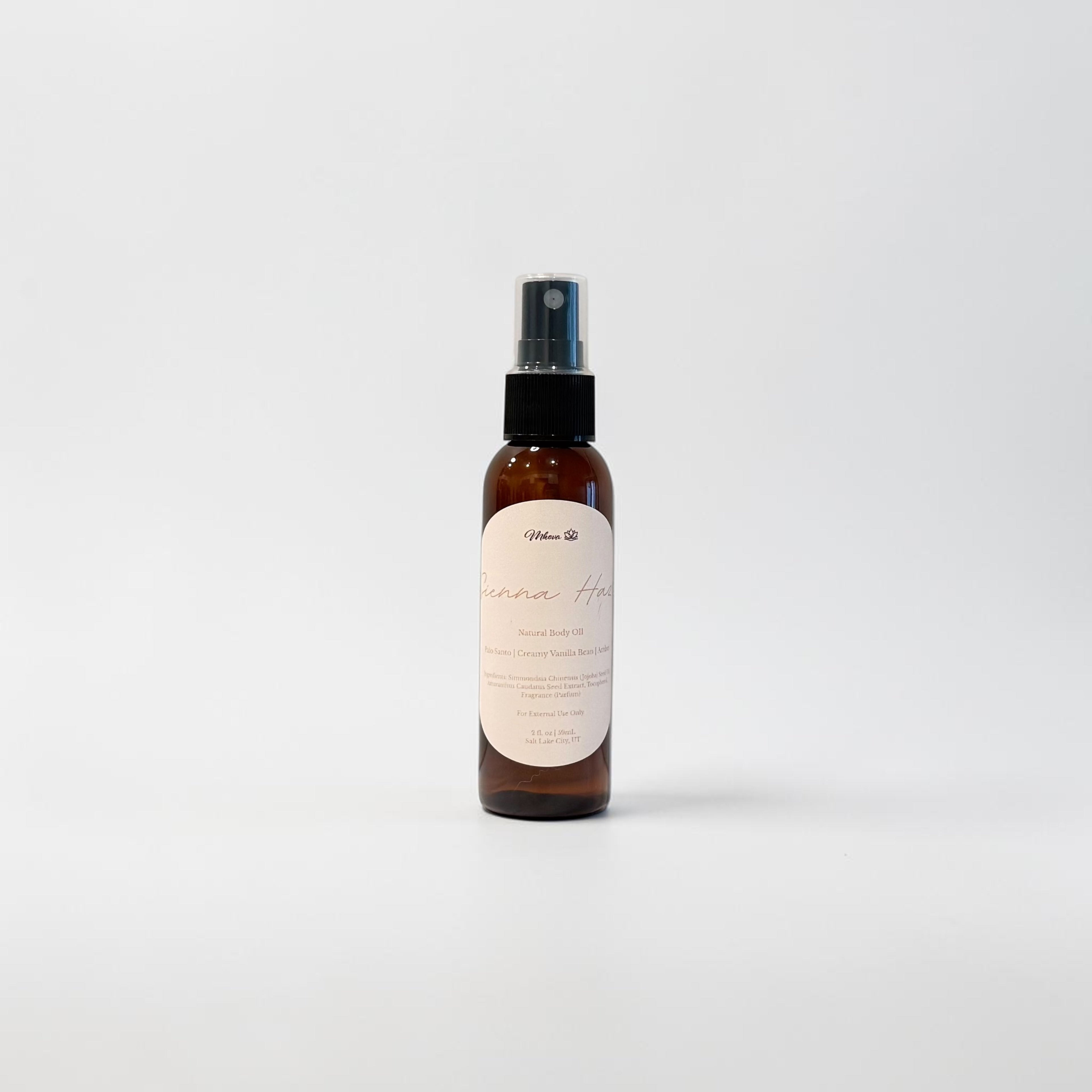 Sienna Haze Body Oil — warm palo santo, creamy vanilla bean, and golden amber photographed on a clean white background.