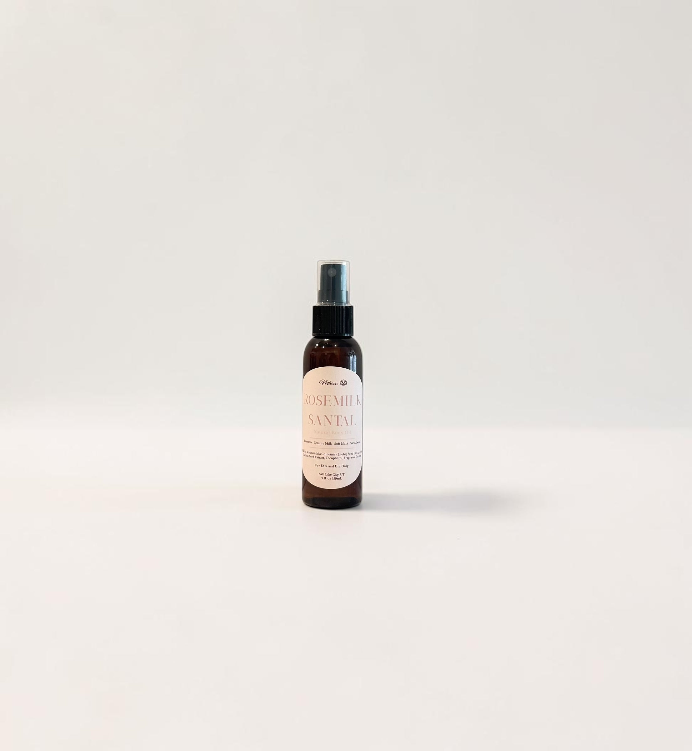 Rosemilk Santal Body Oil — fresh rose, creamy coconut milk, and soft santal woods photographed on a clean white background.