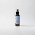Blue Moon Dream Body Oil — rich cocoa butter and soft cashmere photographed on a clean white background.