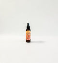 Bellini Babe Body Oil — juicy mango, ripe peach, creamy passionfruit, and soft sandalwood photographed on a clean white background.